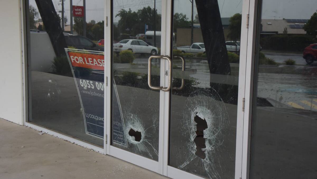 SMASHED IN: Front windows of shops in Wagga Road have been badly damaged. The five shops are presently unoccupied.