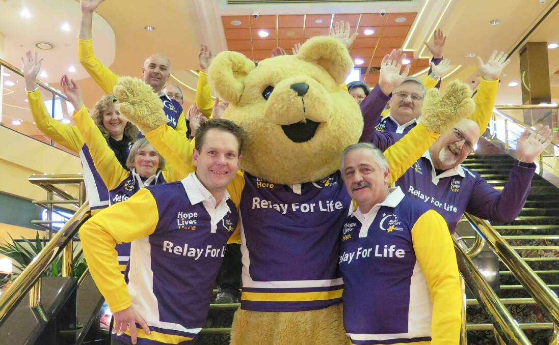 JOIN THE CAUSE: Border Relay for Life chairman Carl Friedlieb, Dougal the bear and the Commercial Club's Ian Bohun with the purple committee. They held a meeting on Tuesday night in preparation for the 2016 event.
