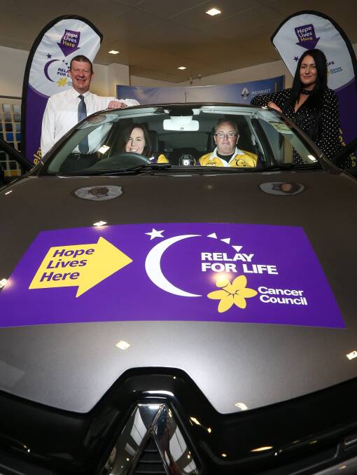 BIG RAFFLE: Relay for Life committee members Kate Wilkinson and Peter Whitmarsh sit inside the major prize with Jeff Duck and Kaitlyn Goodsell. Picture: JAMES WILTSHIRE