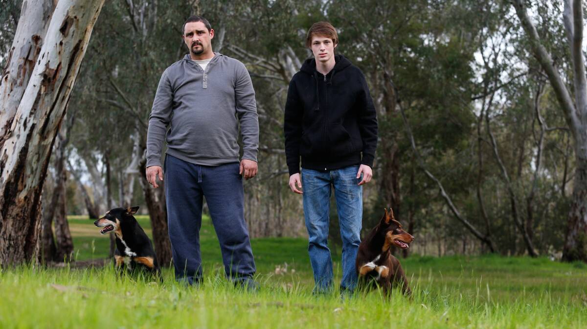 Missing: Doug Prenter and Liam Walsh with their pet dogs Bundy and Leila. Their third dog Gizmo is believed to have been stolen in Wodonga. Picture: MARK JESSER