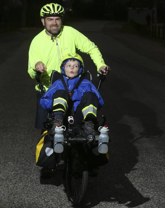 TEAM EFFORT: Travis and Patch, 7, in their semi-recumbant tandem bike, which they tested out in Albury before jetting overseas. Picture: ELENOR TEDENBORG