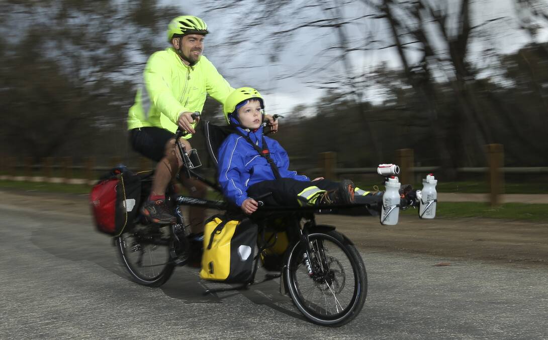 LEARN ON THE GO: Travis Saunders with his son Patrick, 7, who will ride 5000km from west to east across the US. Picture: ELENOR TEDENBORG