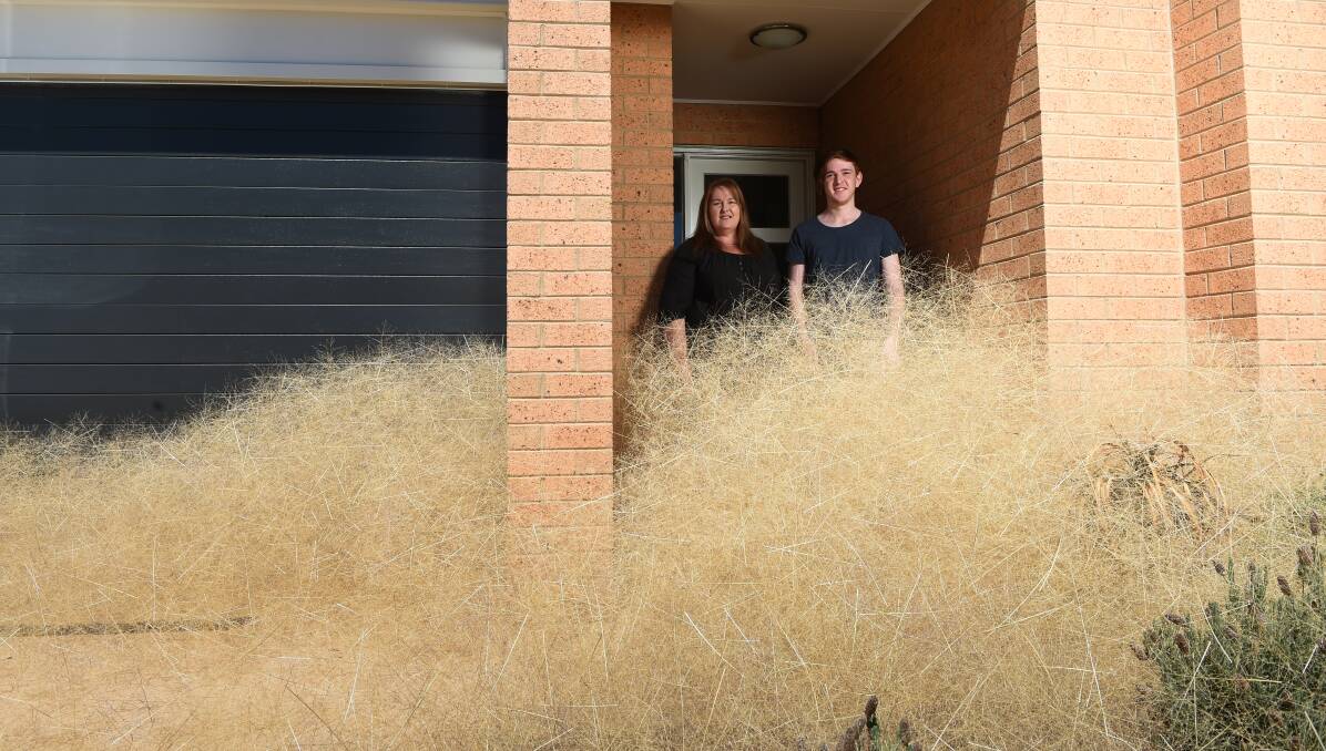 SHUT THE FRONT DOOR: Michelle and her son Logan Parisi, 19, have been bombarded by tumbleweeds in Wangaratta. Picture: MARK JESSER