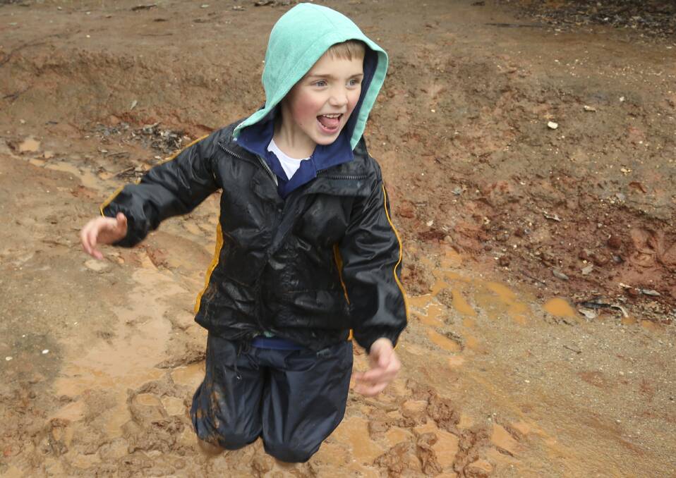 SINKING GROUND: Elijah Kinning, 6, of North Albury wasn't put off by the rain. Instead he embraced the wet weather and jumped into some mud.