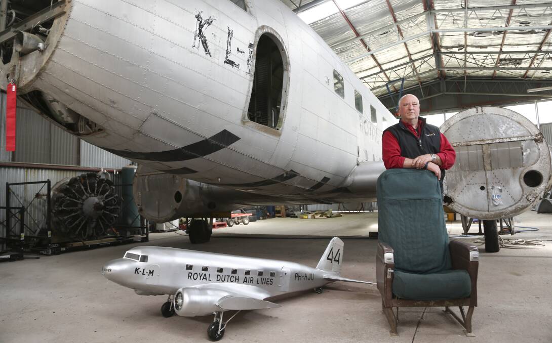 GAINING ITS WINGS: Trust chairman Pieter Mol in the hangar with the Uiver, the model plane and the donated chair. Picture: ELENOR TEDENBORG