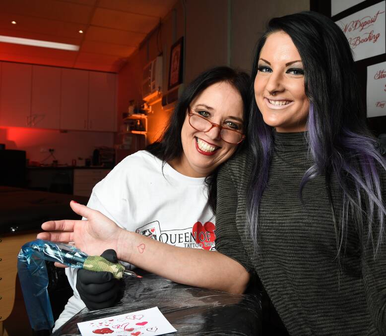 SPREADING THE LOVE: Donna McMillan with Alicia Johnson who will be inking-up heart tattoos for a gold coin donation on Saturday to raise money for the Heart Foundation. Picture: MARK JESSER