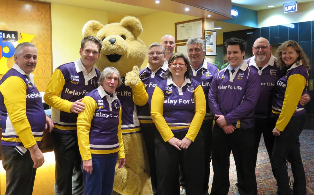 JOIN THE CAUSE: Dougal the bear joins the purple committee at a meeting on Tuesday night in preparation for the 2016 event. The community is encouraged to sign up for Relay for Life on Saturday.
