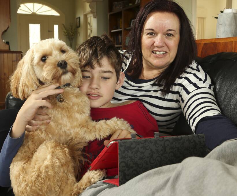 LEARNING RESOURCE: Rusty the dog, Yasmin Keating and her son Aaron, 11, all feature in Riverina Shore, a virtual community that students use to learn about people living with different disabilities. Picture: ELENOR TEDENBORG