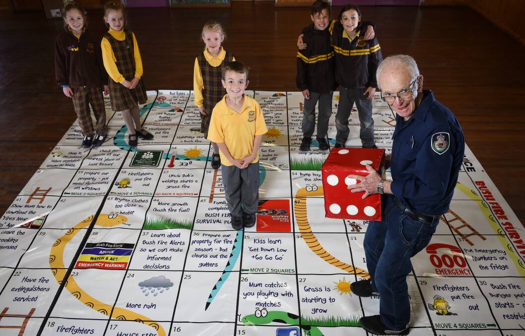 READY TO ROLL: Peter Farry with Lavington Public School grade 2 students, who learned about fire safety through his game. Picture: MARK JESSER