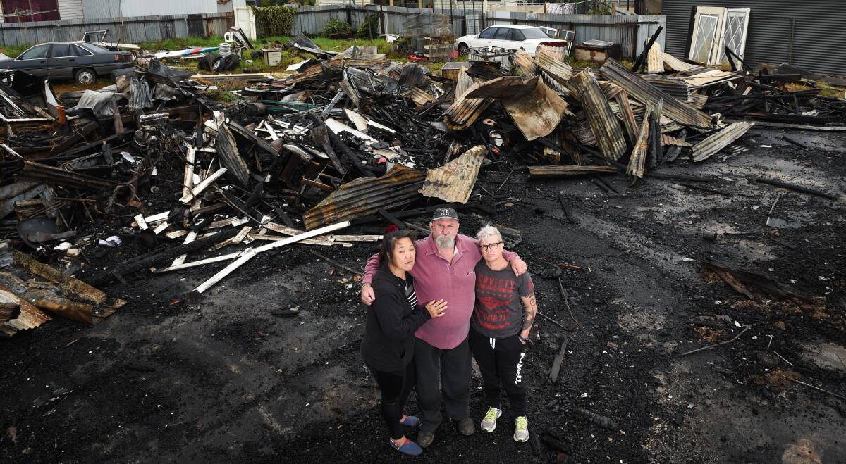 GUTTED BY FLAMES: Ping Lim, Jeffrey Simmons and daughter Vicki Simmons are working to rebuild the bric-a-brac shop. Pictures: MARK JESSER