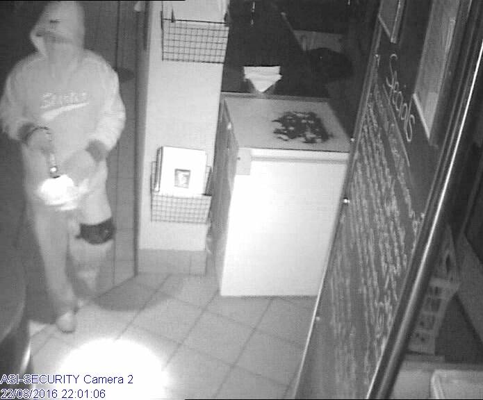 WELL EQUIPPED: Hooded thief caught on CCTV as he enters Cafe Grove about 10pm Monday.