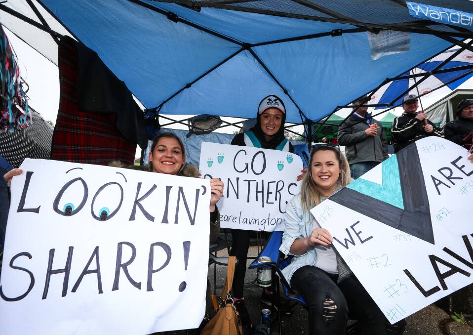 CHEER SQUAD: Panthers supporters Hannah Sharp, Kayla Tait and Hayley Trotter were prepared with signs and a gazebo on Sunday.