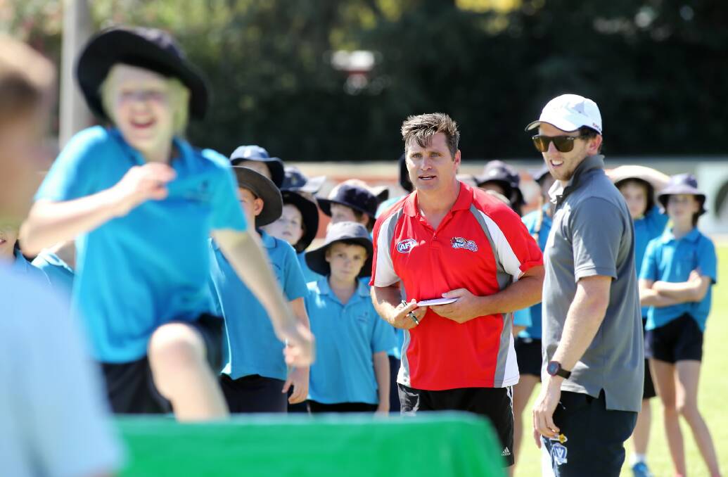 Shane Crawford encourages kids through the drills during yesterday’s Auskick launch. Picture: JOHN RUSSELL