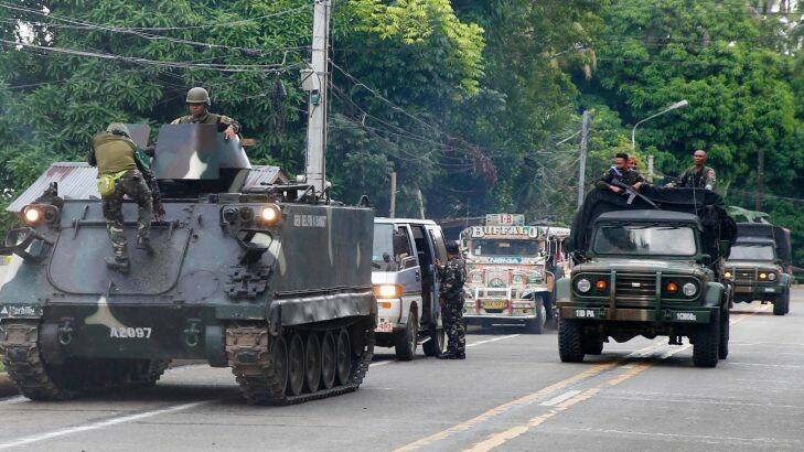 Tanks arrive at a military camp in Iligan city to reinforce Government troops who are battling Muslim militants who laid siege in Marawi city for over a week now Wednesday, May 31, 2017 in southern Philippines. Fighting continues for the second week now between Government troops and Muslim militants with casualties on both side and civilians.(AP Photo/Bullit Marquez)