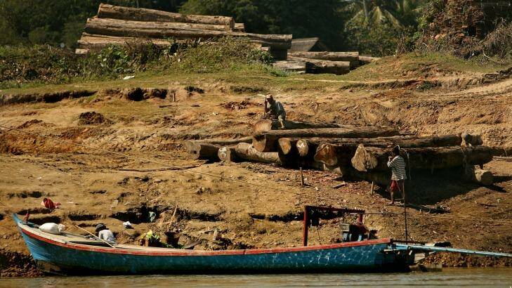 Men working with logs on the banks of the Irrawaddy River between Bhamo and Shwegu in Kachin state, Myanmar.  Photo: Kate Geraghty