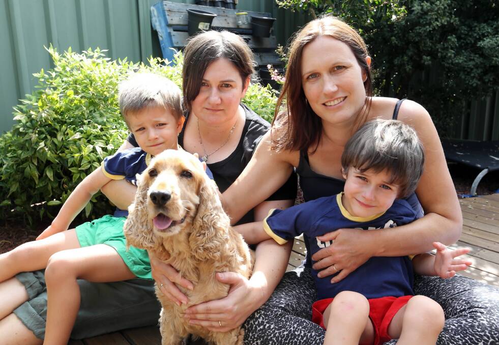 Jane Gardiner and her partner Angie Salske with their children, Ari, 3, and Rio, 5, and their dog, Bently, who was attacked by another dog at Lake Hume on Sunday. Picture: PETER MERKESTEYN