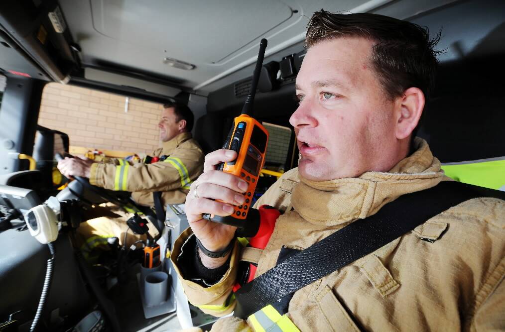 Wodonga CFA leading firefighter Matthew Johnson and station officer David Brown with one of the hand-held units capable of broadcasting and receiving the new digital signal. Picture: JOHN RUSSELL