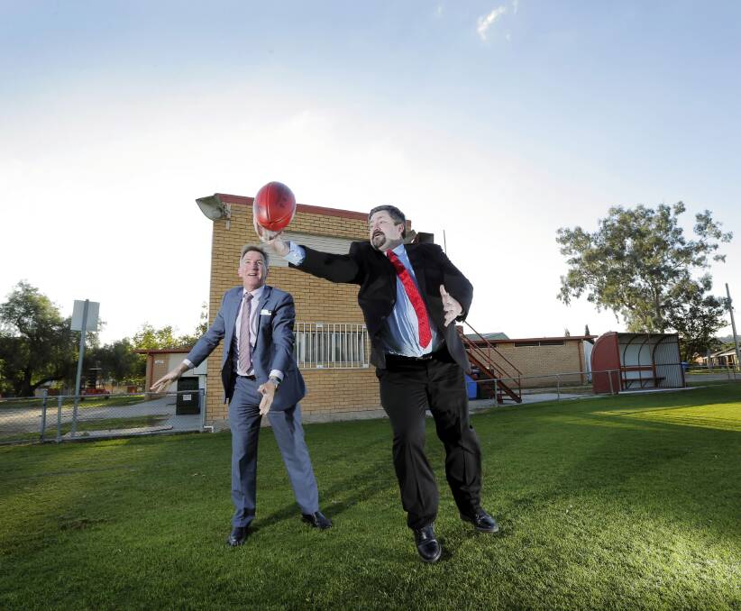 Albury mayor Cr Kevin Mack and Cr Darren Cameron pass the football at the Urana Road Oval. Picture: TARA GOONAN