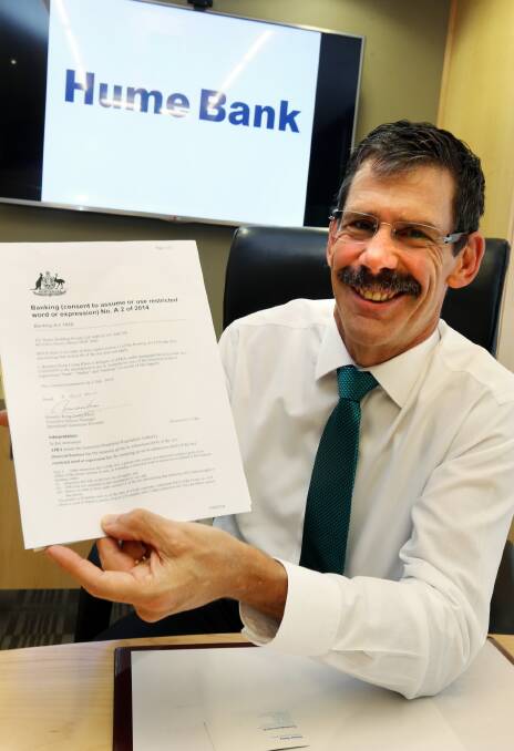 Signed, sealed delivered: Andrew Saxby shows off the letter confirming the Hume Building Society can now call itself a bank. Picture: PETER MERKESTEYN