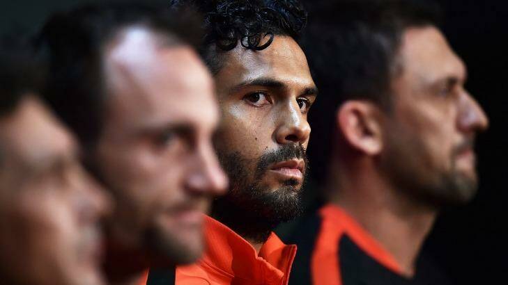 Resolve: Wanderers captain Nikolai Topor-Stanley and coach Tony Popovic (third and far right) can end a long drought for Western Sydney's football fans. Photo: Daniel Kalisz