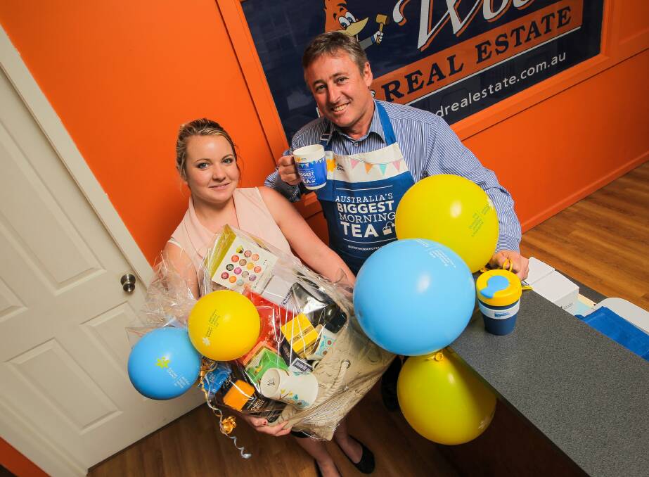 With the balloons and goodies in hand, Greg Wood and Chevy Dryden are primed for tomorrow’s morning tea at his agency. Picture: DYLAN ROBINSON