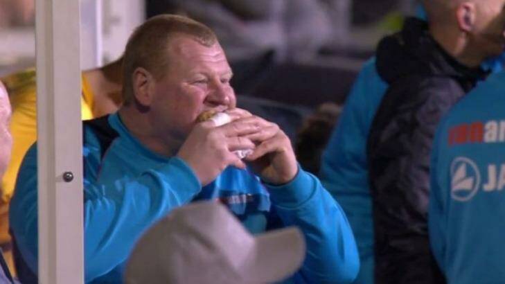 Tucking in: Wayne Shaw eats a pie in the dug-out during the game. Photo: BBC
