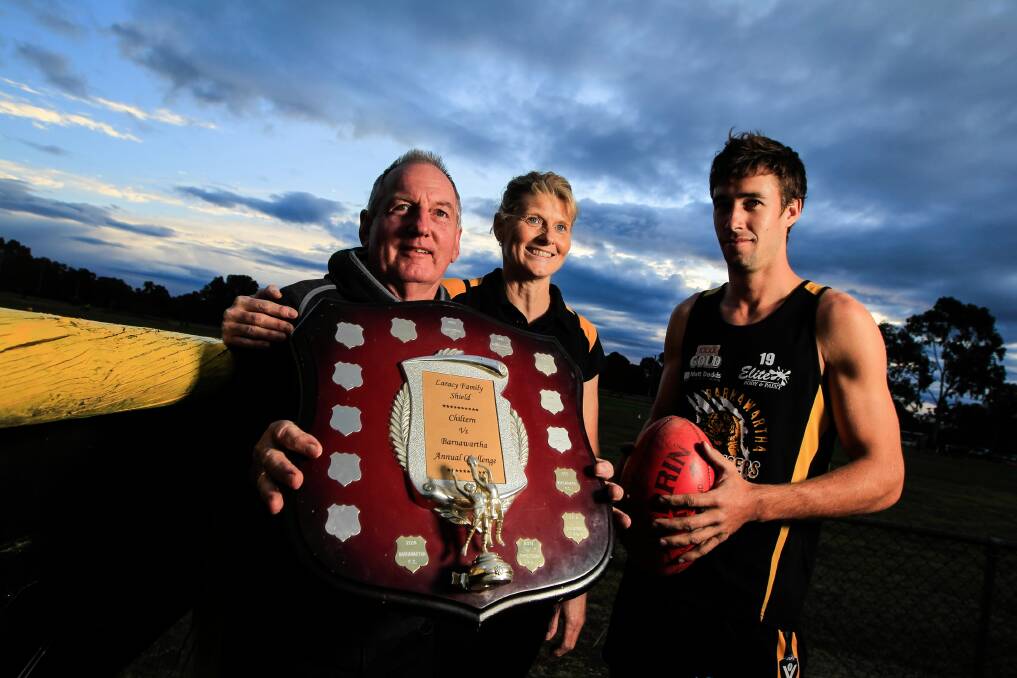 Frank and Kath Laracy and Barnawartha co-captain Josh Spence with the Laracy Shield, which will be up for grabs when the Tigers meet Chiltern.