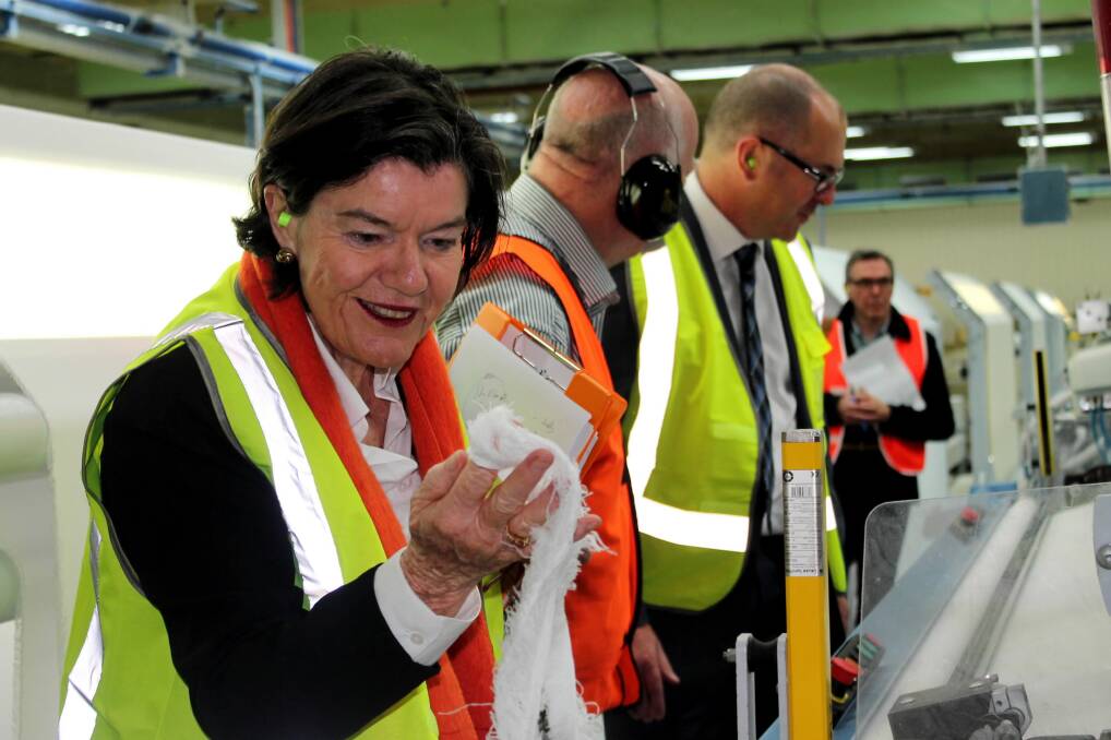 Cathy McGowan inspects fabric during a visit to the Australian Textile Mills factory in Wangaratta yesterday.