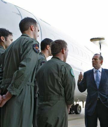 Tony Abbott speaking to troops at RAAF Base Williamtown: The Prime Minister has applauded Thursday morning's counter-terrorism operation, saying there was clear evidence the would-be terrorists planned to commit demonstration beheadings in Sydney. Photo: Melina Young
