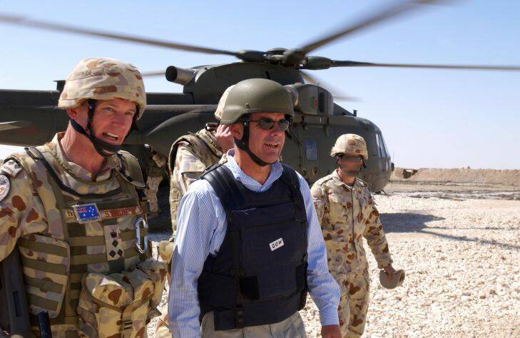 The Minister for Defence, Dr Brendan Nelson and the Commander of the Australian Joint Task Force, Brigadier Paul Symon (left), walk from a British EH101 Merlin helicopter on which they flew into the Al Muthanna Task Group base at Camp Smitty, in southern Iraq, Saturday, March 4, 2006. Dr Brendan Nelson and the Chief of the Defence Force (CDF), Air Chief Marshal Angus Houston visited Australian troops deployed to the Middle East as part of Operation Catalyst. Operation Catalyst is the ADF??????s contribution to the reconstruction and rehabilitation of Iraq. Operation Catalyst commenced on July 16, 2003, and currently comprises 1320 ADF personnel. (AAP Image/Defence) NO ARCHIVING, EDITORIAL USE ONLY
