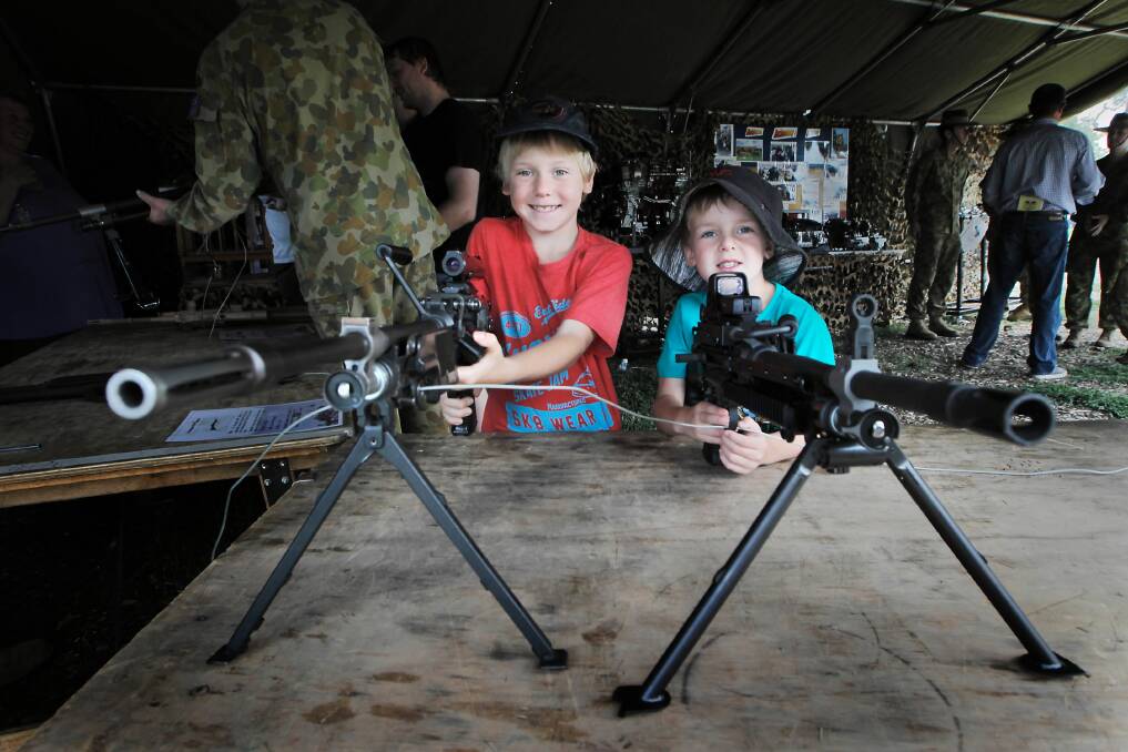 Yackandandah’s Charlie Smith-Allen, 8, and brother Paddy Smith-Allen, 5, checking out some army weaponry.