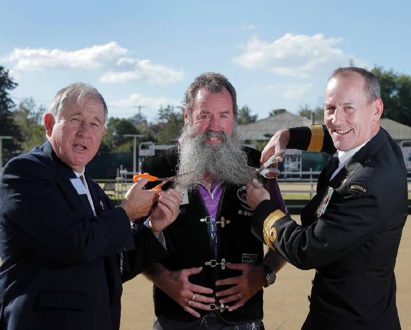 Pictured preparing to give Mike Bell a shave are president of the Holbrook RSL David Hocking and Australian Navy Director General Submarine Capability, Commodore Peter Scott. Picture: TARA GOONAN