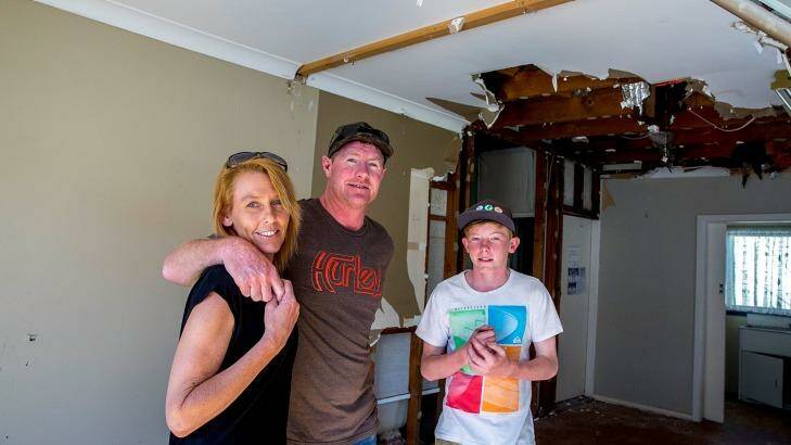 Tracey and Gavin Sant with oldest child Drew, 14, inside their damaged home. Photo: Michele Mossop