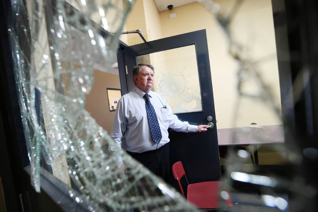 Wodonga Senior Secondary College principal Vernon Hilditch surveys some of the damaged caused in the attack on the school. Picture: JOHN RUSSELL