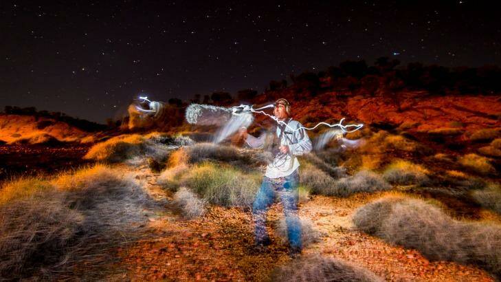 Ecologist Steve Murphy among the spinifex, searching for the elusive night parrot's call. Photo: Justin McManus