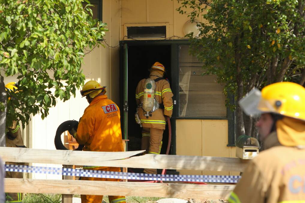 Firefighters at the scene of the house fire that broke out in Spring Avenue, Wodonga, yesterday afternoon.