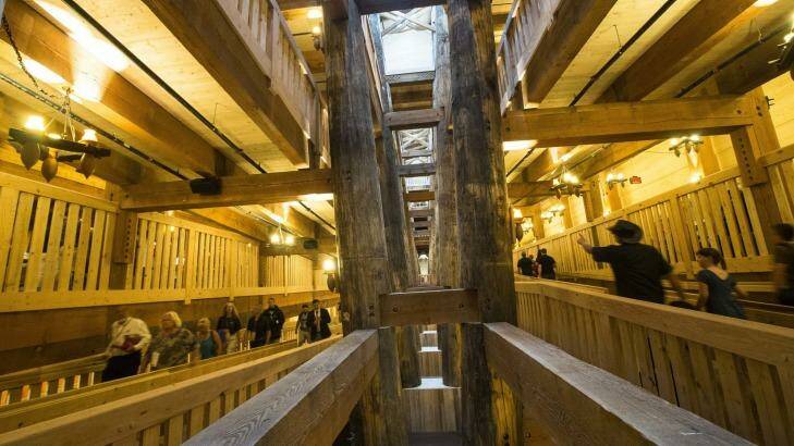 Visitors pass along the central support beams of a replica Noah's Ark. Photo: John Minchillo
