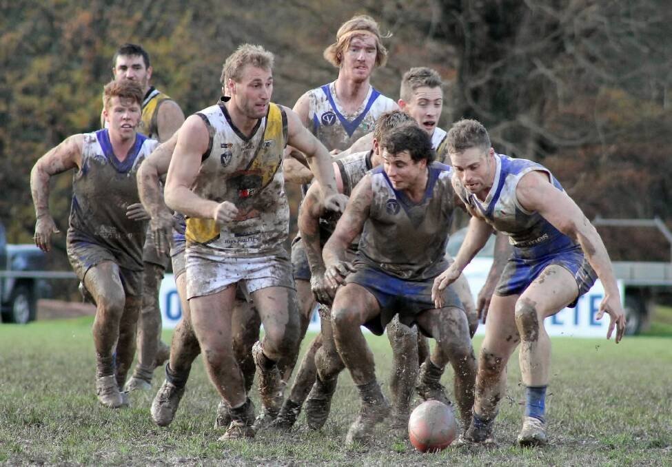 Bright’s Jake Pronk and Regan Alexander get their heads over the ball in the Mountain Men’s monumental  five-point win over Glenrowan in muddy conditions on Saturday.  Picture: GILLIAN JONES