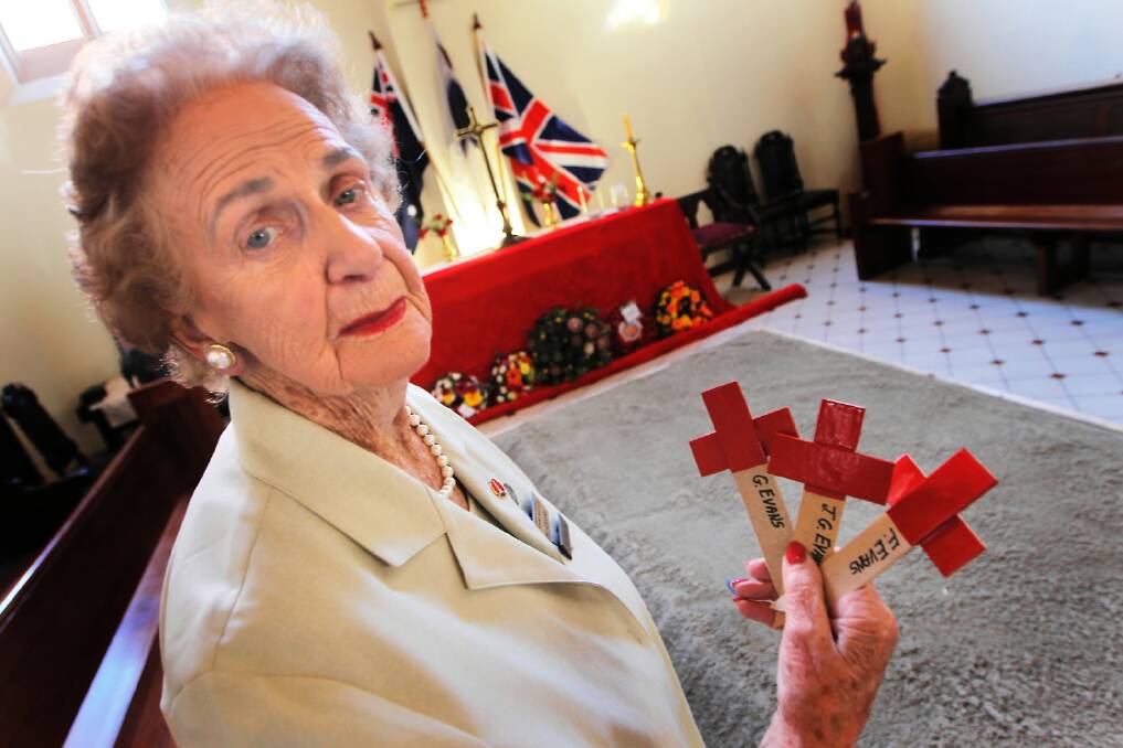 Albury and District War Widows’ Guild president Val Evans places a cross at yesterday’s Field of Remembrance ceremony at St Matthew’s Church. Pictures: DYLAN ROBINSON