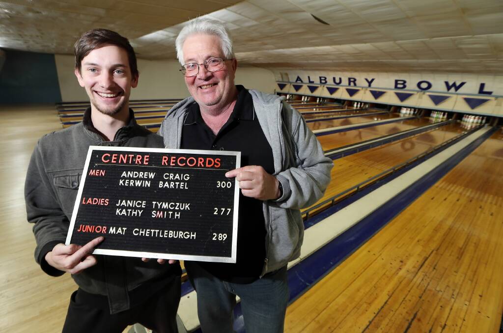 One for the records books ... titleholders Mat Chettleburgh and Andrew Craig show the statistics that will go down in history now that the Albury Tenpin Bowl has closed. Picture: JOHN RUSSELL
