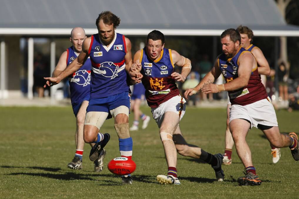 Tarrawingee’s Trevor Edwards and Whorouly’s Matt Hill collide as Josh Kelly prepares to swoop. Pictures: WANGARATTA CHRONICLE