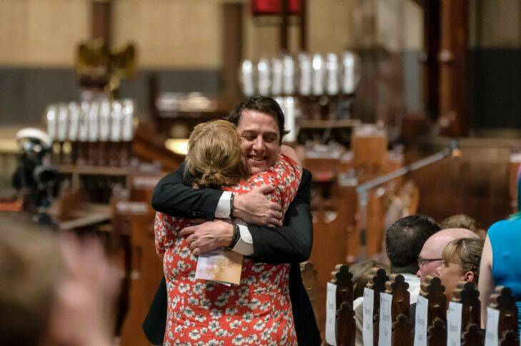 MELBOURNE,AUSTRALIA 23 SEPTEMBER 2017: Samuel Johnson brother of Connie Johnson' is greeted during her memorial at St Paul's cathedral in Melbourne on Saturday 23 September 2017..Photo Luis Enrique Ascui