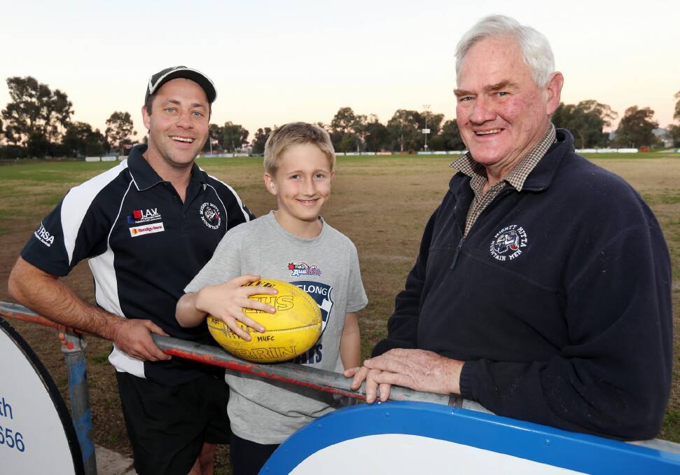 Looking ahead ... Mitta United coach Clinton Gilson discusses his decision to open the Blues’ coaching job with club president Mac Paton and his grandson Will. Picture: PETER MERKESTEYN