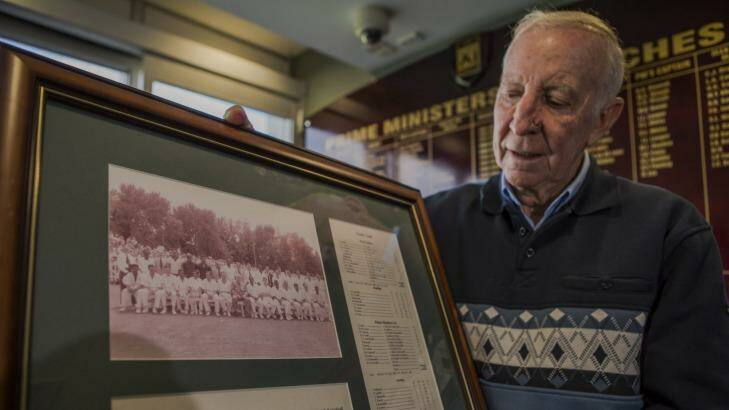 Canberra's John Cope, with the team photo of the 1961 Prime Minister's XI team and Richie Benaud. Photo: Jamila Toderas