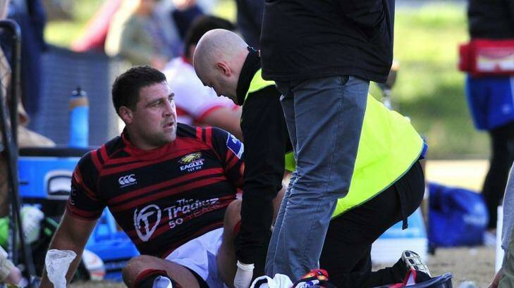 Josh Mann-Rea receives treatment on the sidelines after his injury. Photo: Jeffrey Chan