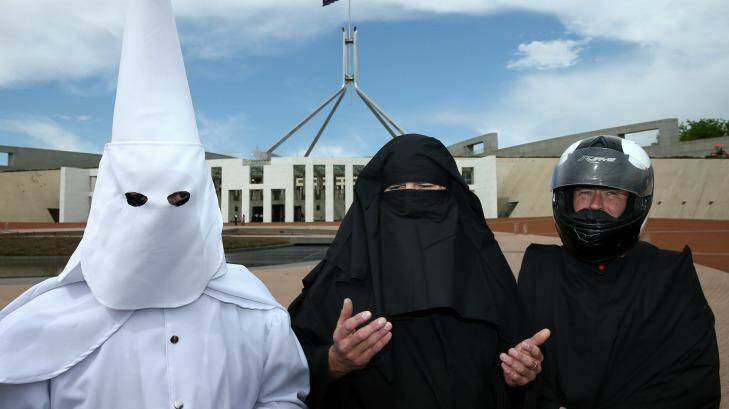 Three men who covered their faces to protest the wearing of the burqa in public places on Monday. Photo: Alex Ellinghausen