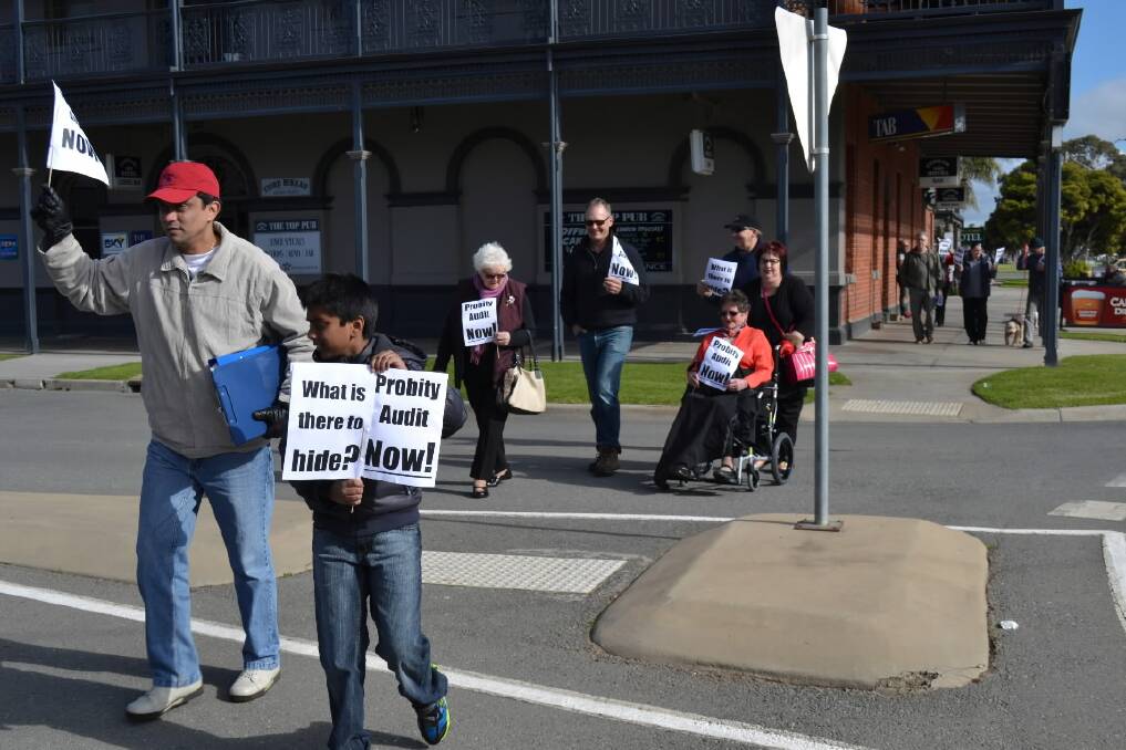 Former Moira Shire chief financial officer Adrian Pawar and his son Jake Pawar, 10, lead a group of about 25 protesters. Picture: COBRAM COURIER