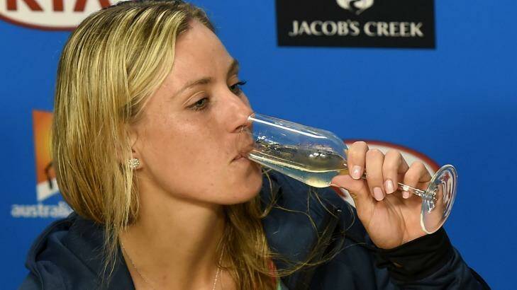 Angelique Kerber sips on champagne during the press conference. Photo: Andrew Brownbill