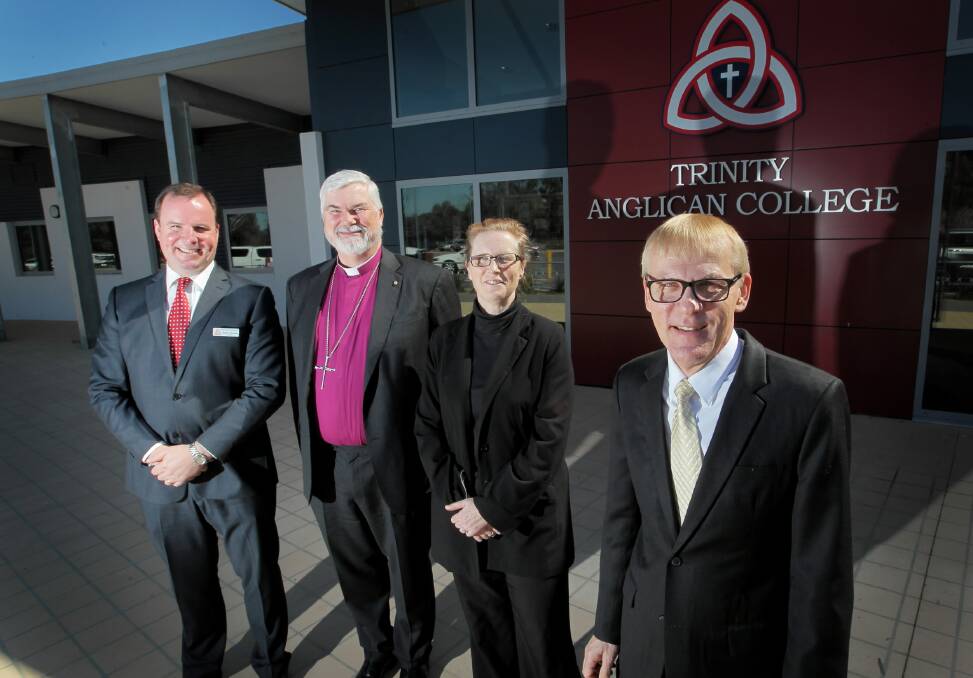 Principal Steven O’Connor, Bishop of Wangaratta Reverend John Parkes, board chairwoman Professor Julia Coyle and the Anglican schools commission chief the Reverend Peter Laurence after they sealed the deal yesterday to make Trinity part of the commission. Picture: DAVID THORPE