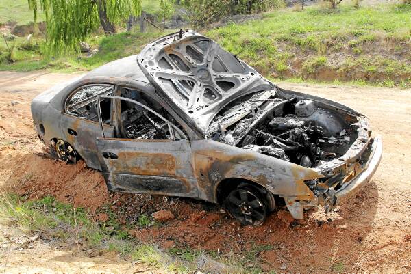 The Holden Commodore was gutted by the fire, which started near Huon Creek. Picture: BLAIR THOMSON